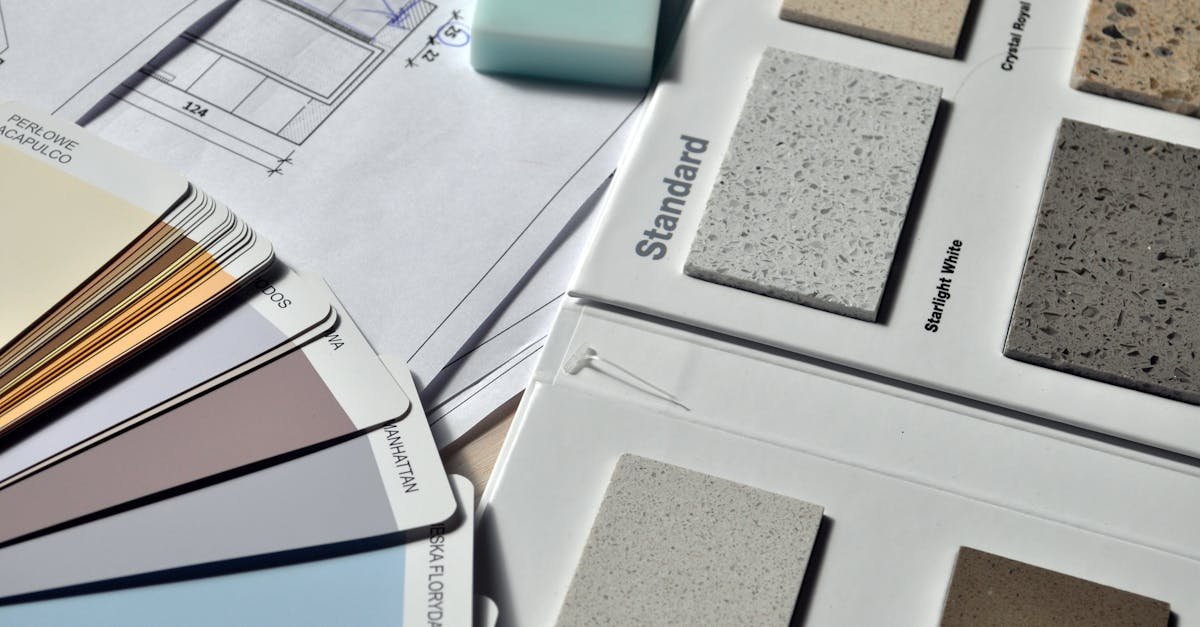 Color palette and material samples for interior renovation projects on a blueprint.