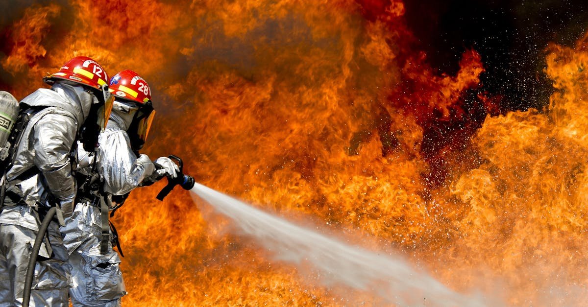 Brave firefighters in action extinguishing a large fire with determination and teamwork.