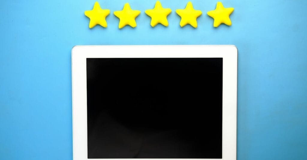 Tablet with five yellow stars on a blue background, ideal for rating concepts.