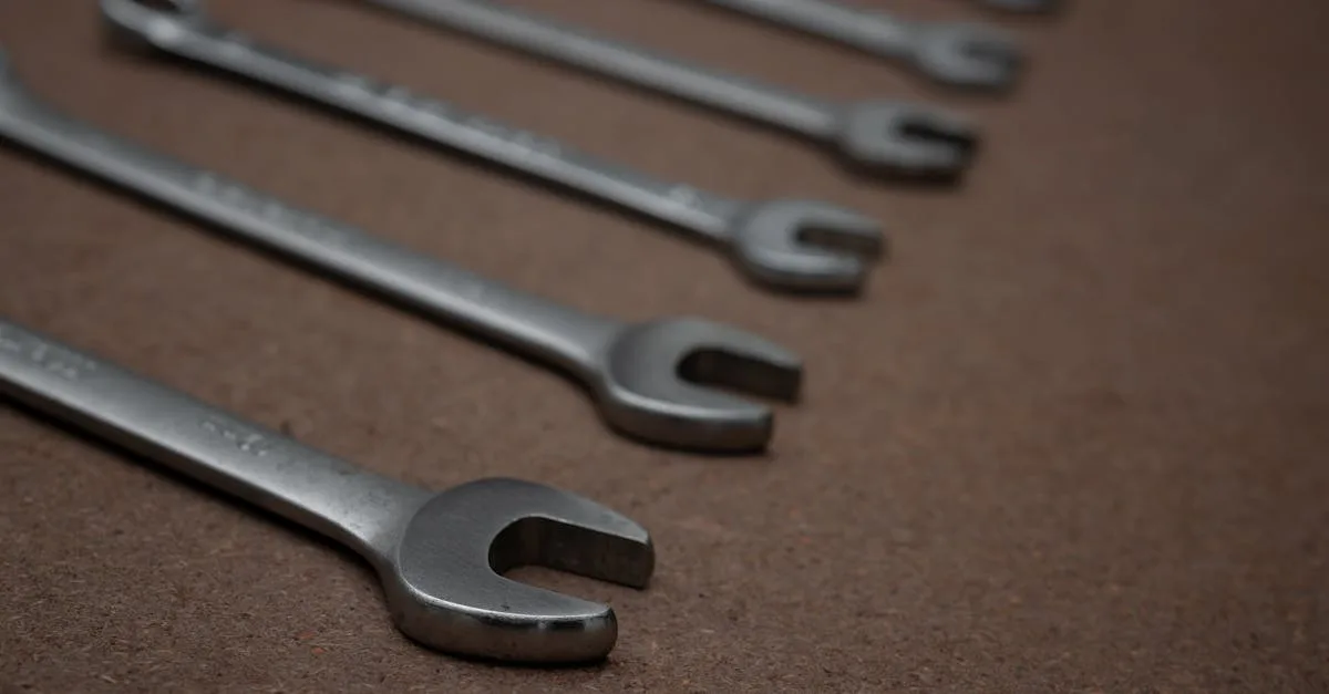 A detailed photo of silver metallic spanners laid on a brown surface.