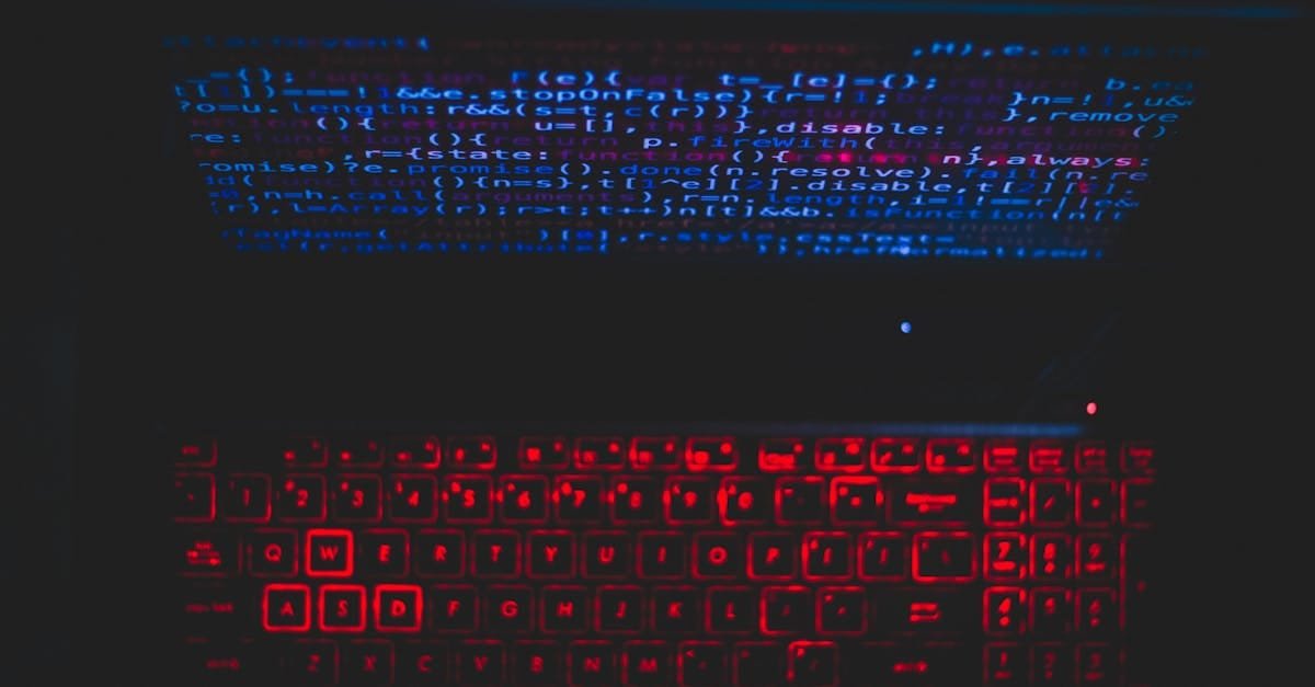 Dark-themed laptop setup with a red glowing keyboard and code on screen, ideal for tech enthusiasts.