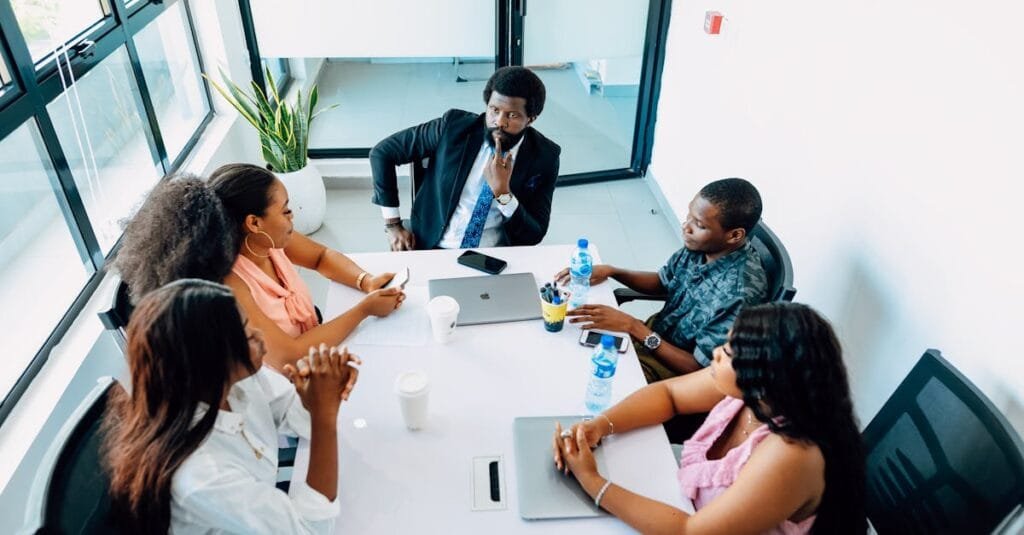A team and their boss sitting in the conference room and having a meeting. Find more afro-centric images at www.ninthgrid.com
