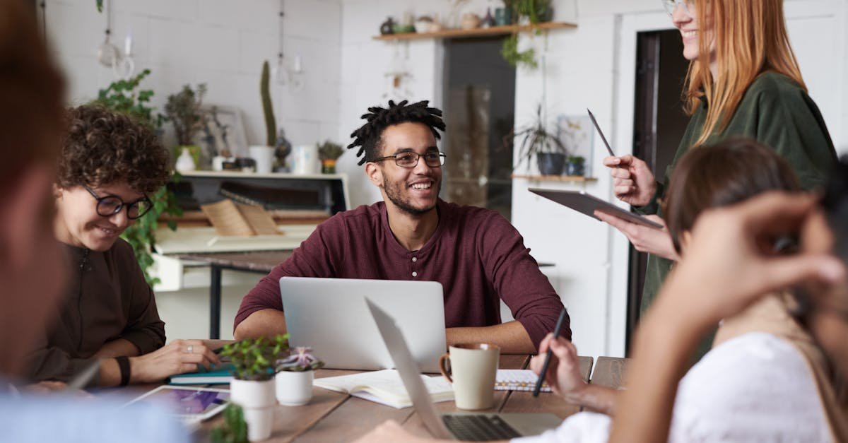 A diverse group of professionals engaging in a productive team meeting in a modern office space.
