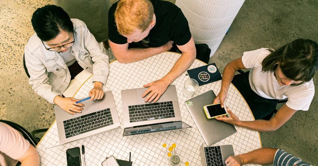 Top view of diverse team collaboratively working in a modern office setting.