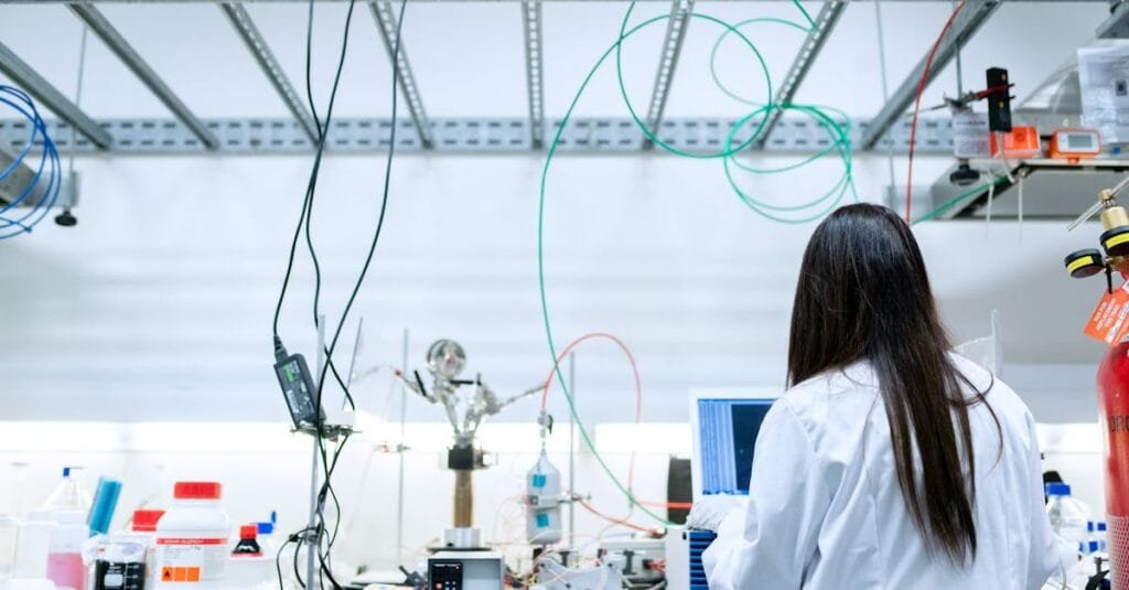 A female scientist conducting research in a contemporary laboratory full of equipment.