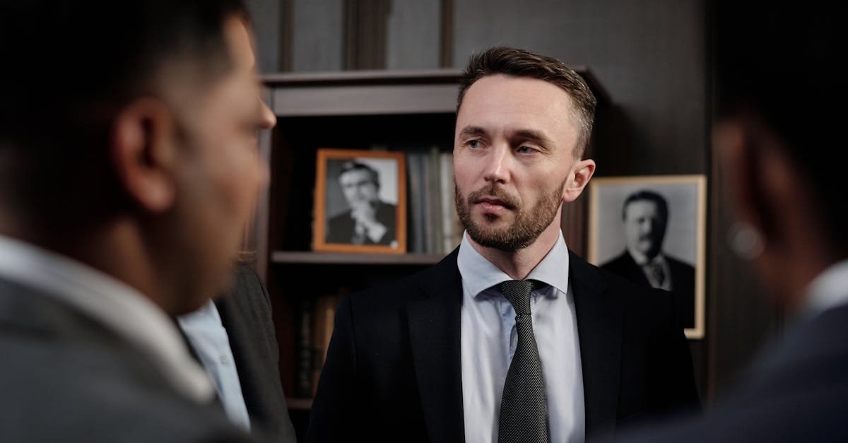 Group of men in suits having a serious business discussion in a professional setting.
