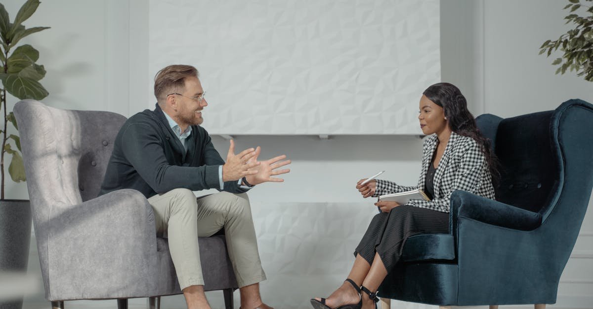 A candid interaction between a man and woman during a professional interview in a modern office setting.