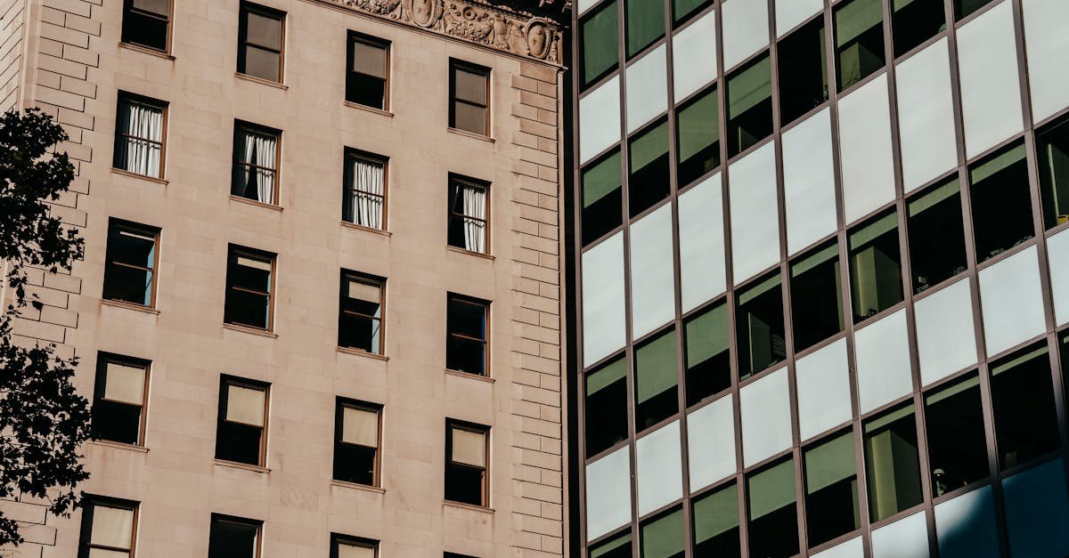 Exterior of stone apartment and glass office buildings located in urban city district in daylight