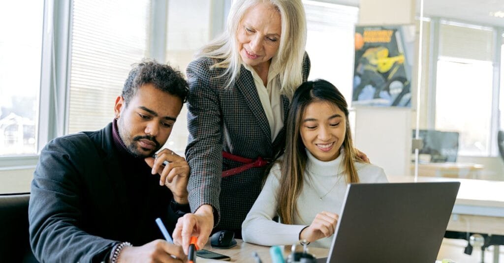 An adult team collaborating in an office environment, focusing on teamwork and diversity.