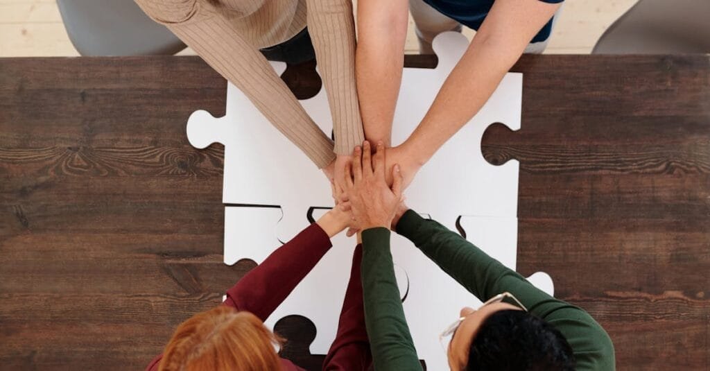 Engaging image of diverse people's hands coming together on puzzle pieces, symbolizing unity.