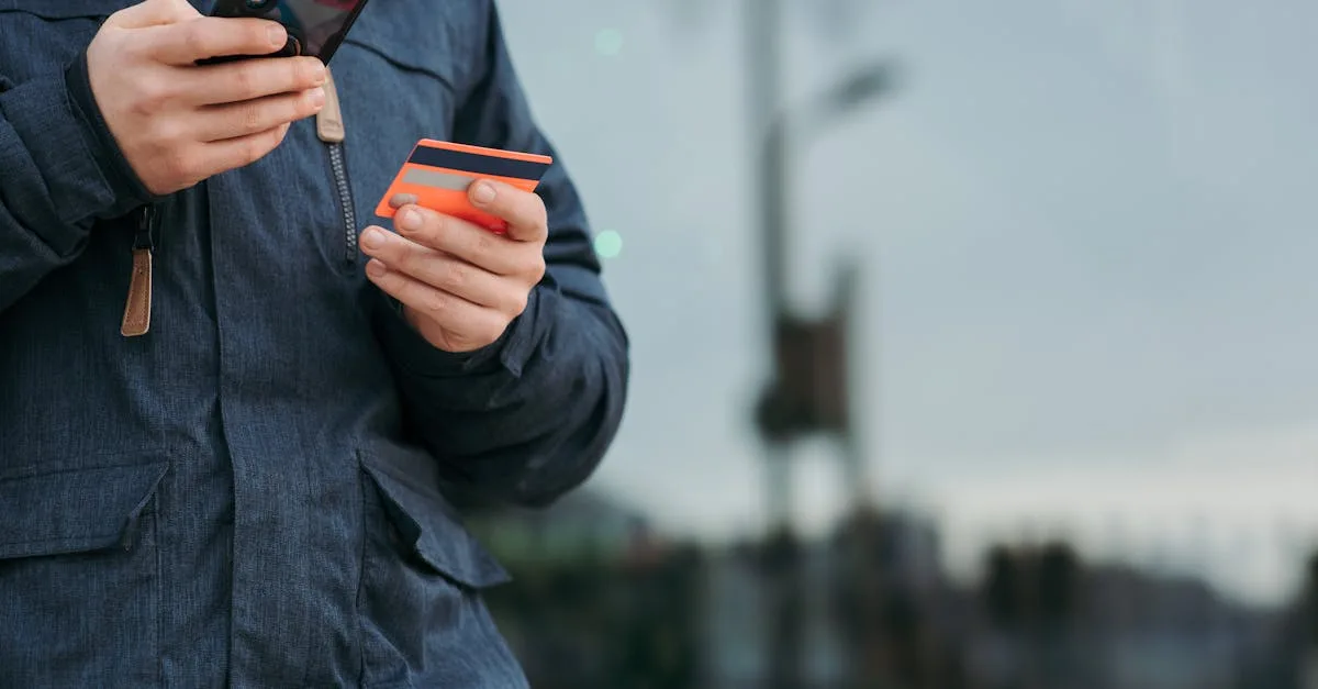 A person outdoors using a smartphone and credit card, illustrating online payments.