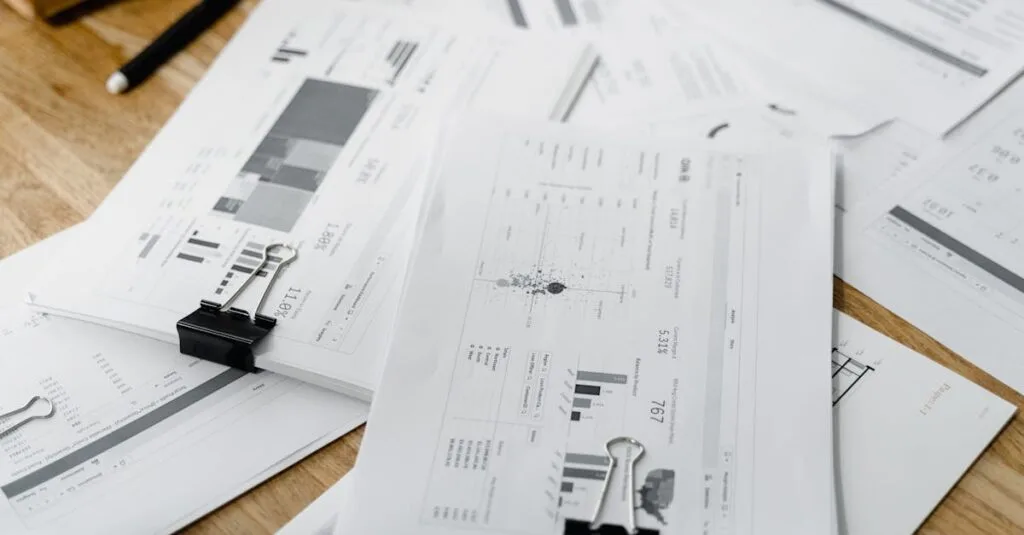A stack of financial reports and graphs with clips on a wooden desk, highlighting business planning.