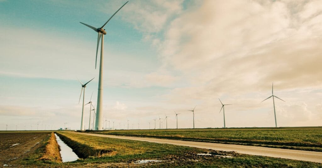 Scenic view of wind turbines in a rural Dutch landscape, generating renewable energy.