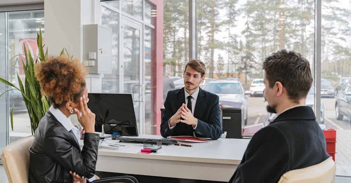 Three adults in a modern office setting having a professional business meeting.