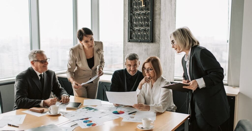 Business professionals engage in an office meeting to analyze data and strategies.