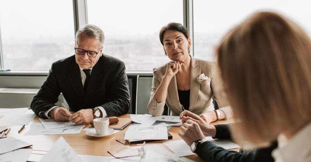 Business professionals in discussion during a meeting in a modern office setting.