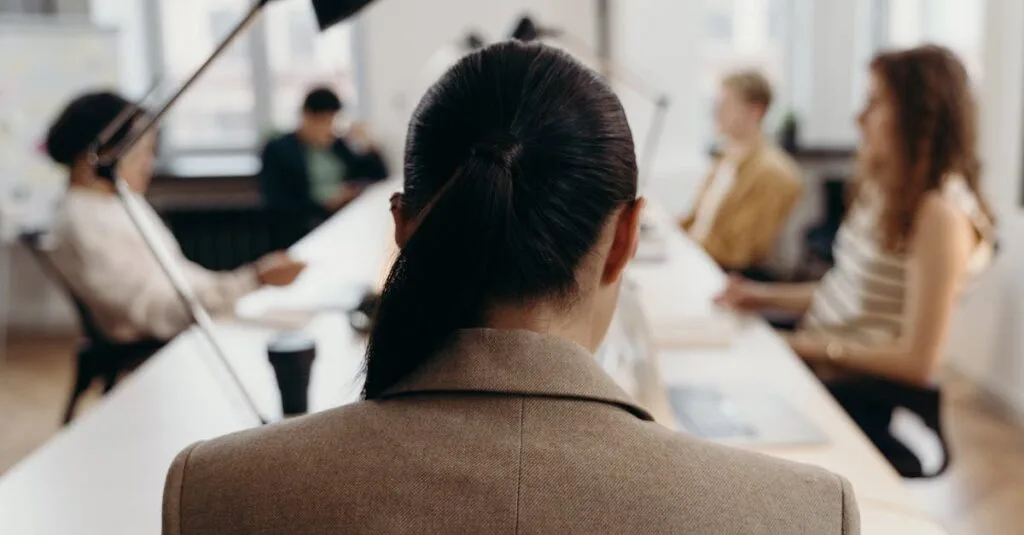 Diverse professionals collaborating in a modern office space, focused on teamwork and project management.