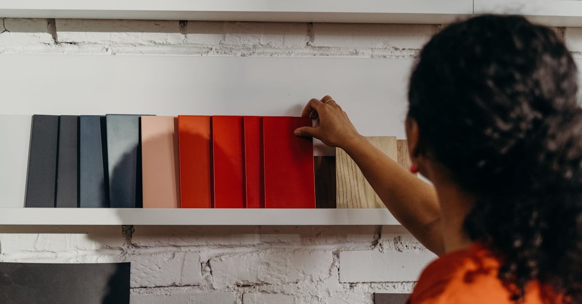 A woman chooses from an array of color samples in a design showroom.
