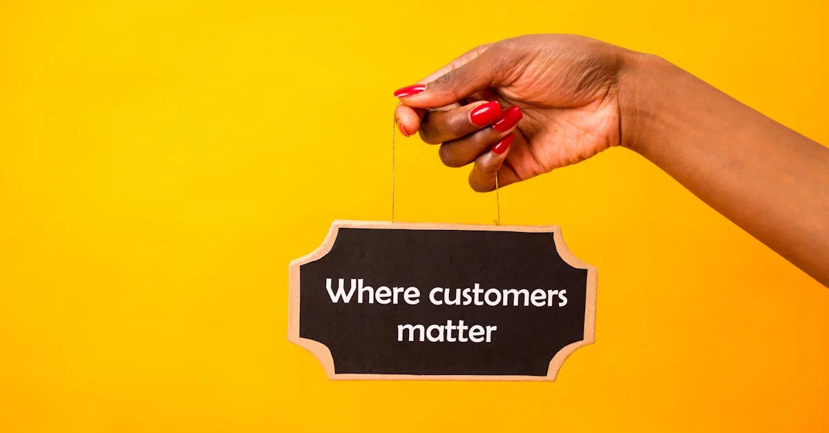 A close-up of a hand holding a sign stating Where customers matter against a bright yellow background.