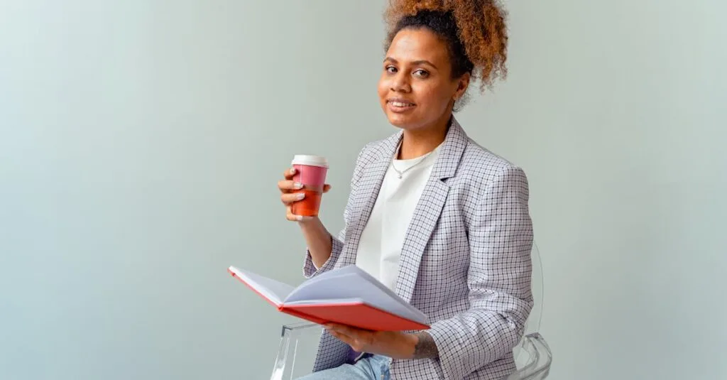 Smiling professional woman holding a coffee and notebook in a light office setting, exuding confidence and knowledge.