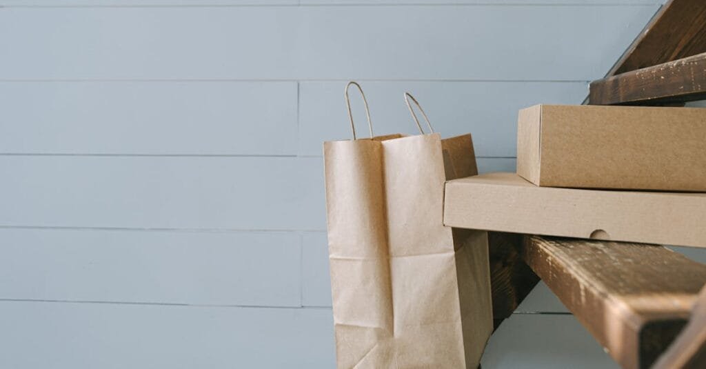 Minimalist image of paper and cardboard packaging on stairs, perfect for e-commerce themes.