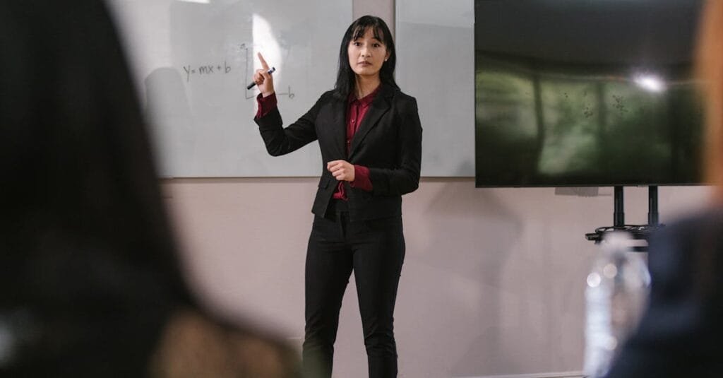 Woman presenting at a business meeting, engaging with the audience in a corporate setting.