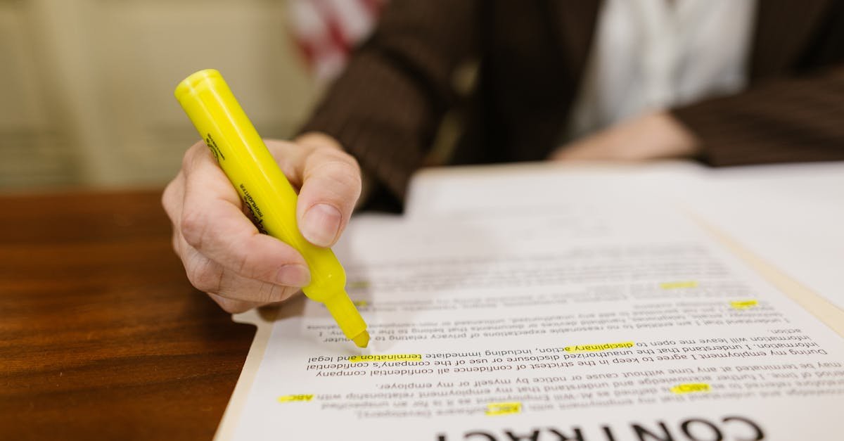 A close-up of a hand highlighting a contract, emphasizing important legal terms.