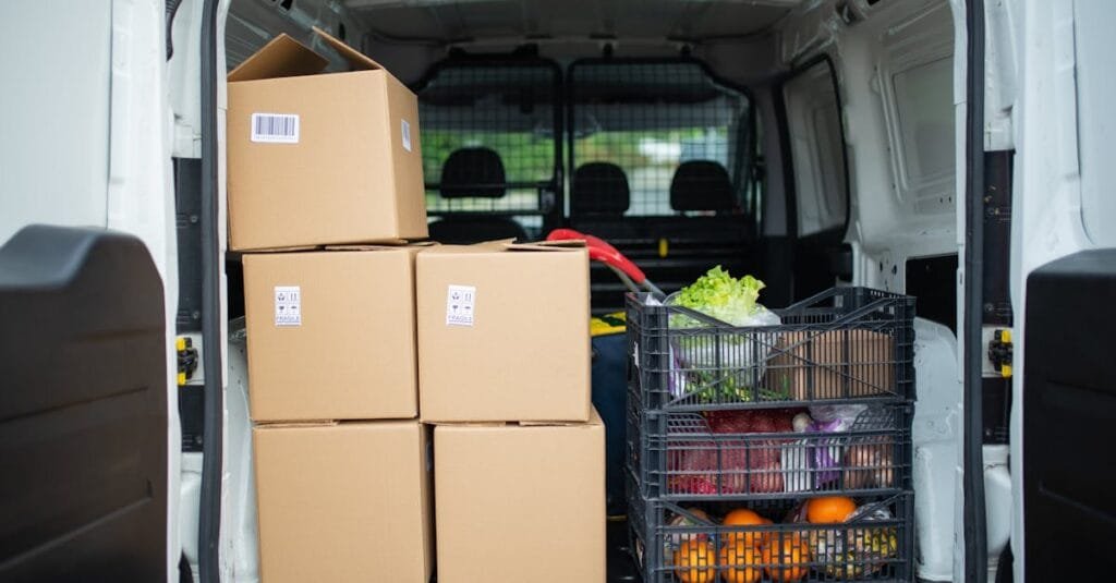 Packed delivery van with boxes and fresh produce crates for efficient logistics.