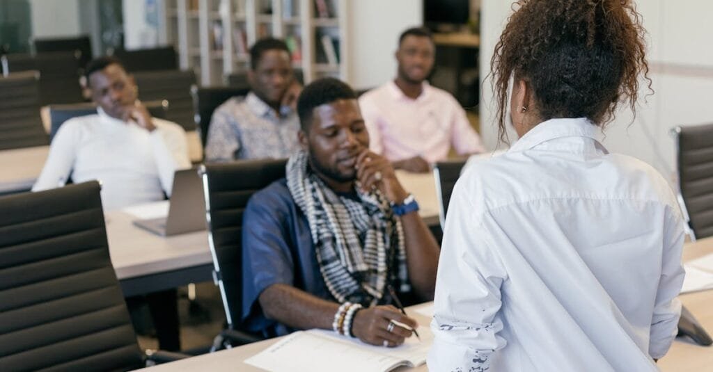 A group of professionals engaging in a training session in a modern office setting.