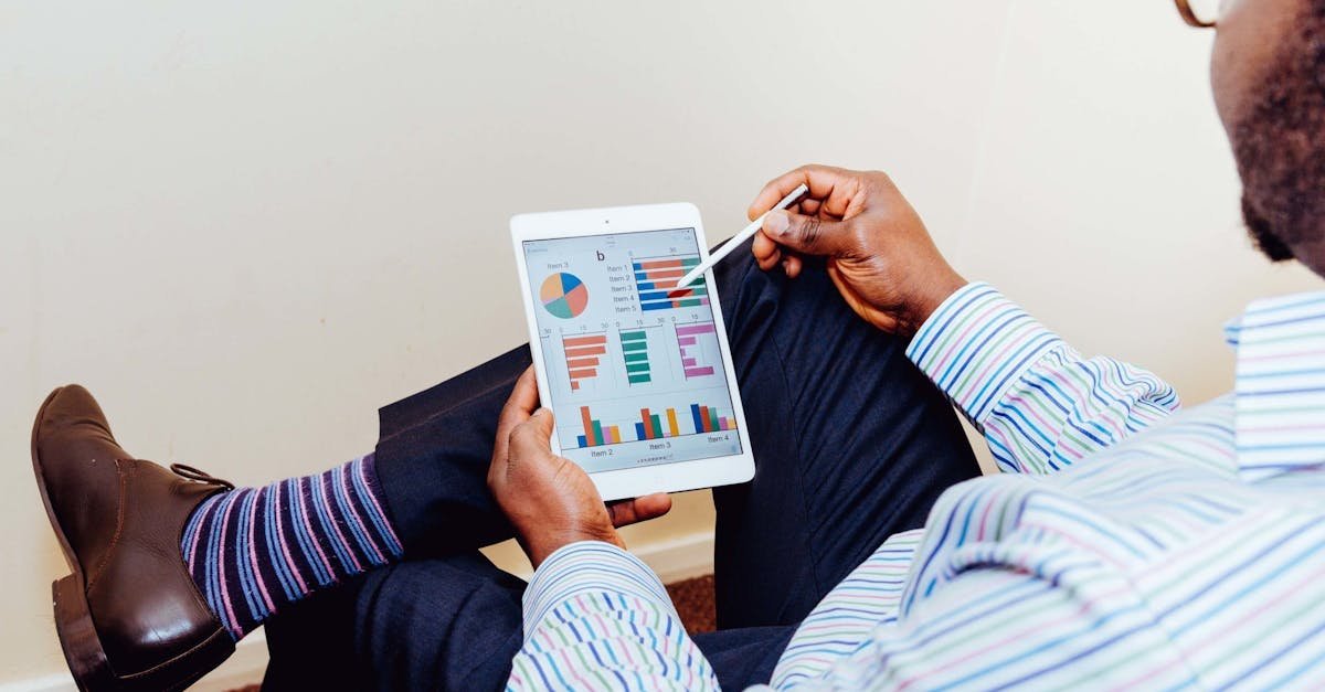 Businessman using a tablet for data analysis in a relaxed office setting.