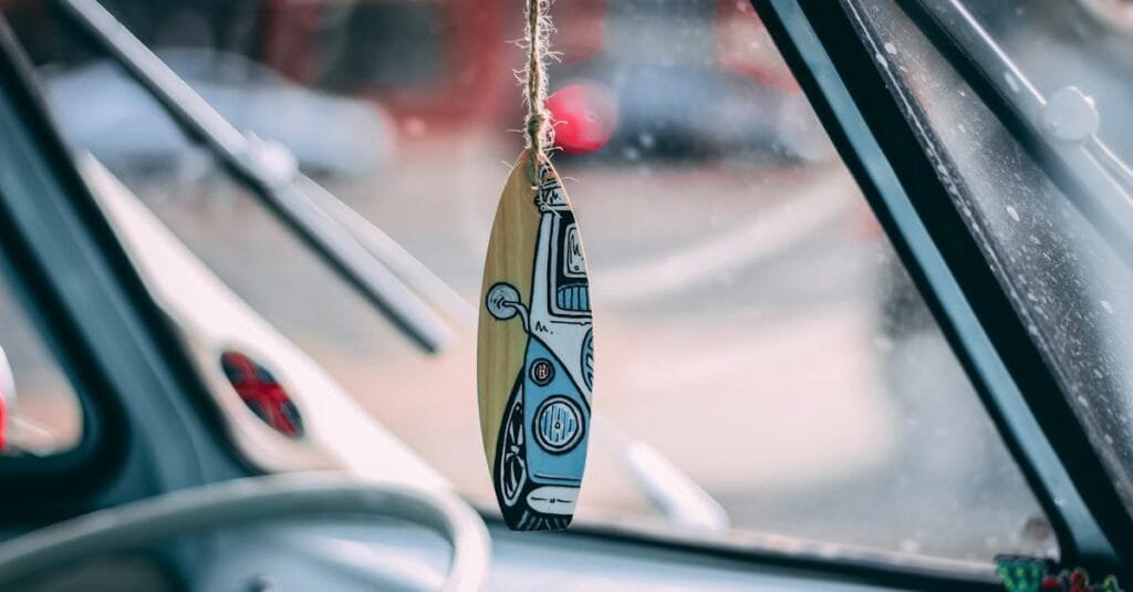 Close-up of vintage VW bus interior with hanging surfboard decoration, captures nostalgic vibe.