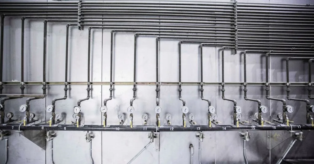 Detailed view of an industrial plumbing system featuring multiple pressure gauges and steel pipes.