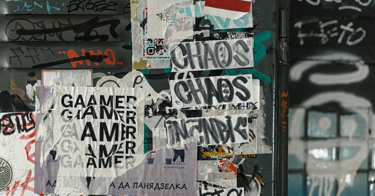 Vibrant urban scene of graffiti and layered posters on a city wall, capturing street art culture.